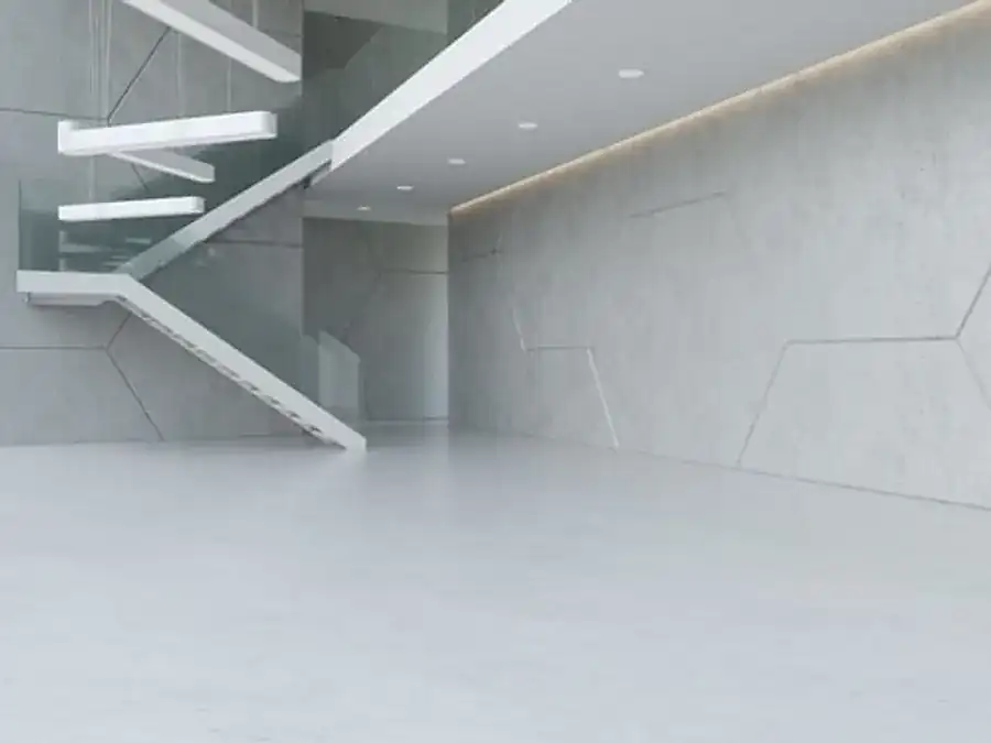 Glossy sealed concrete floor surface reflecting light across a smooth finished slab