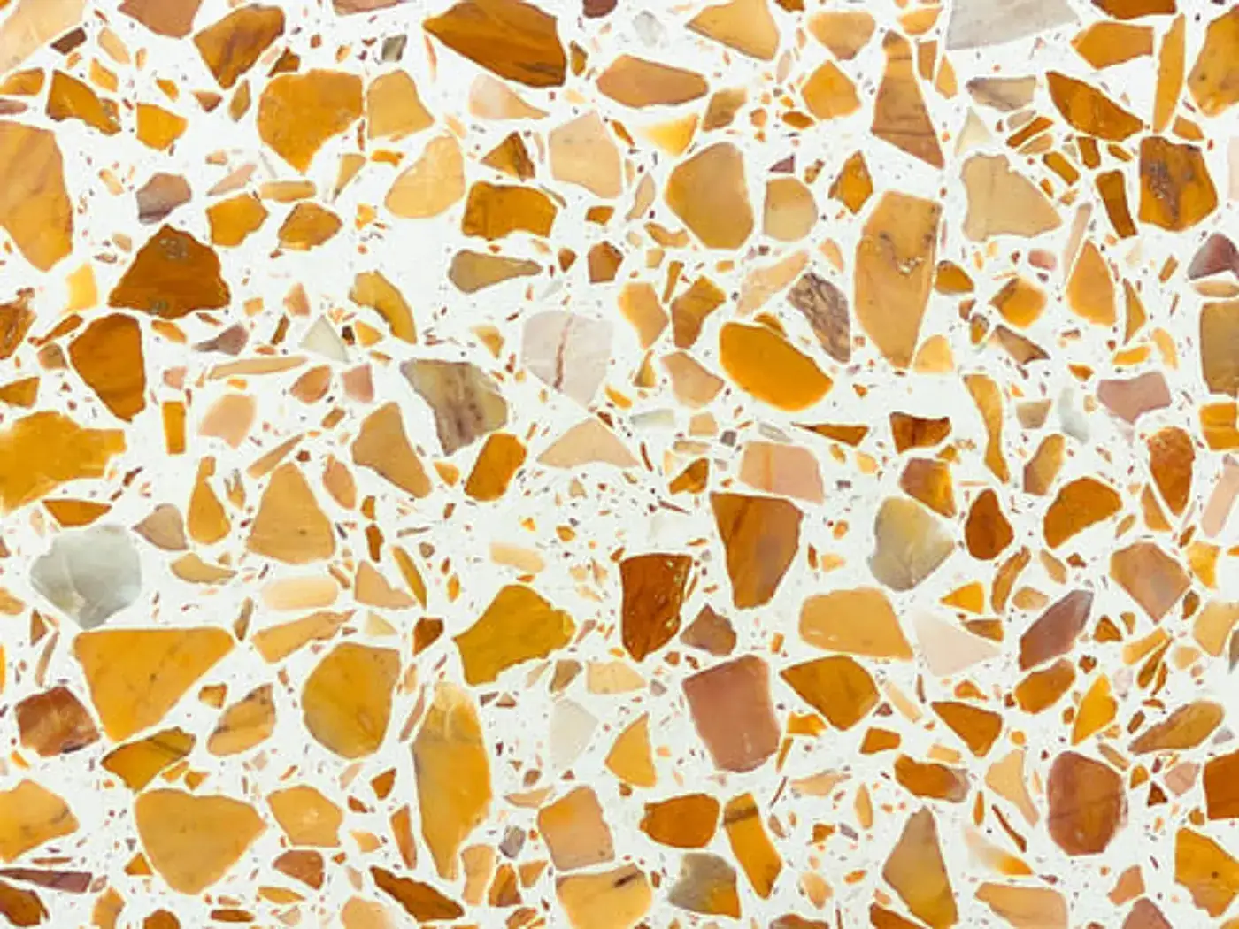 Close-up of a polished terrazzo concrete surface showing warm exposed aggregate
