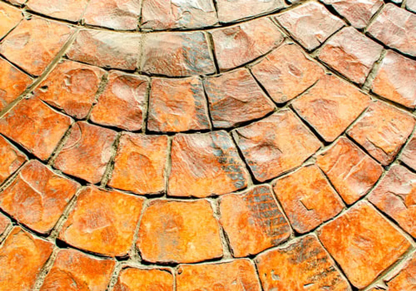 Warm-toned stamped concrete laid in a curved fan pattern on a completed JMV Concrete Inc. project